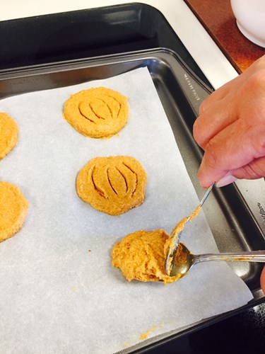 Pumpkin dog treat cookies on baking sheet